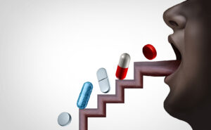 pills going up a tongue shaped as stairs to describe substance abuse concept as over-prescribed medication