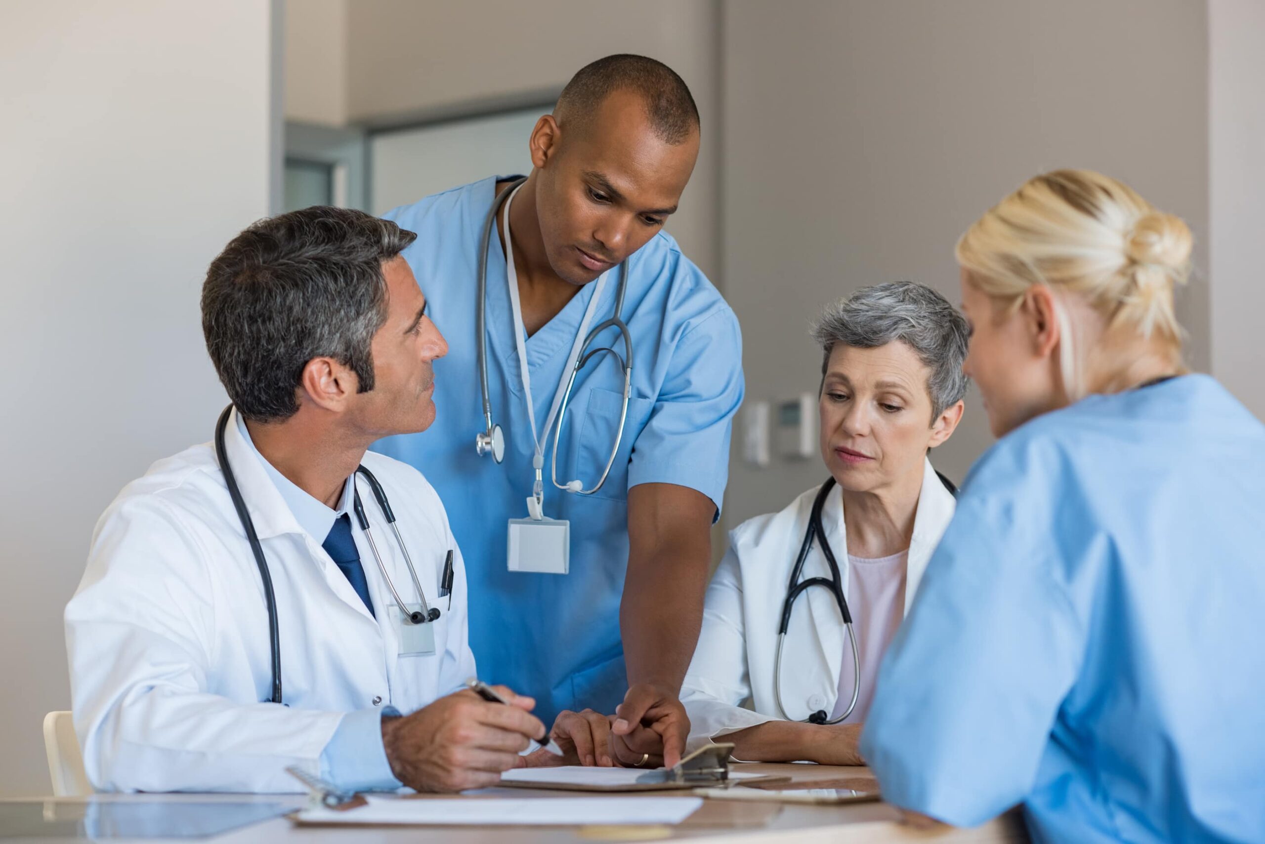 Doctors and nurses sitting around a table discussing percocet treatment