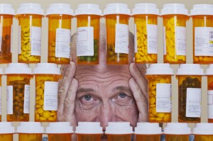 Depressed Senior Man Looking Through Rows of Prescription Medica