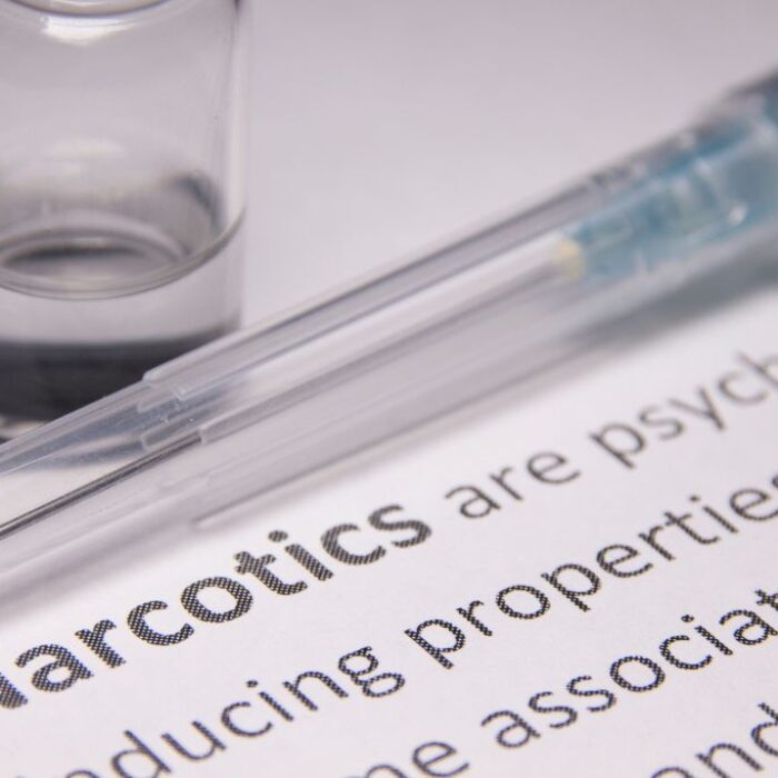 Closeup photo of an encyclopedia page turned to term "Narcotics" and its definition