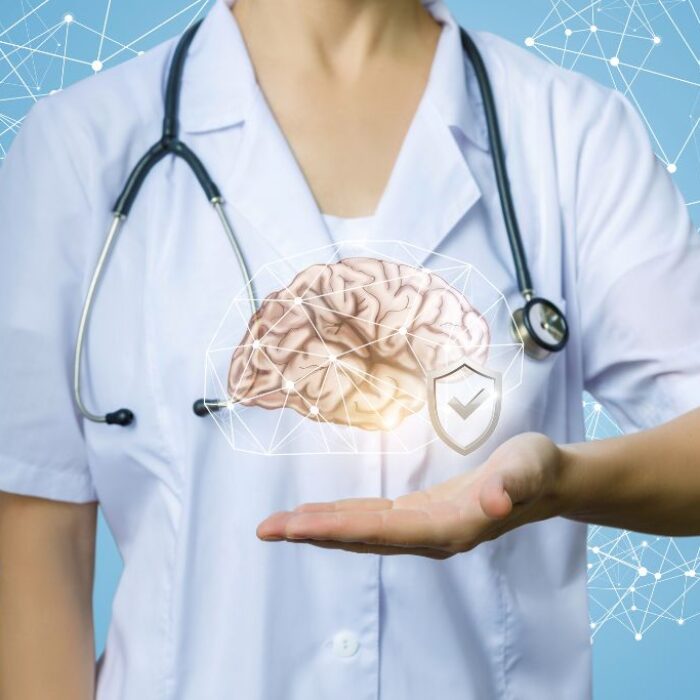 Doctor shows protected human brain on a blue background the idea of protecting brain health and preventing CNS depression.