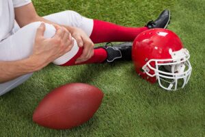 Close-up of injured american football player on the field, concept of opioid addiction in sports