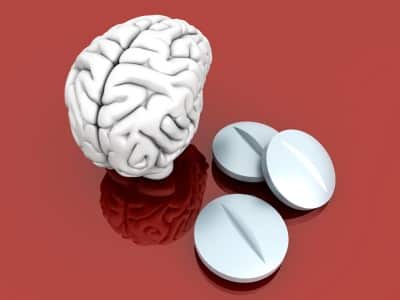 model of brain and opioid pills illustrating prescription painkiller addiction and depression