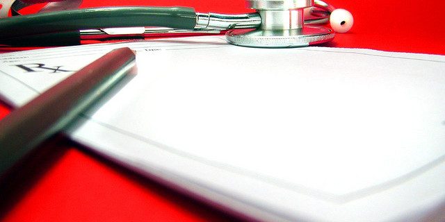 stethoscope on top of clipboard with RX symbol in red background