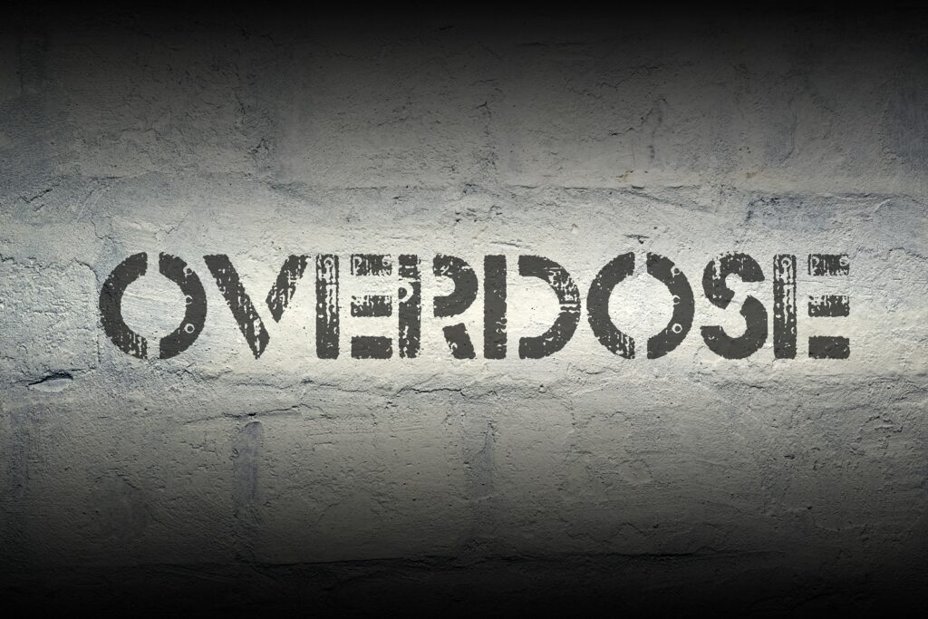 overdose stencil print on the grunge white brick wall | Drug overdose