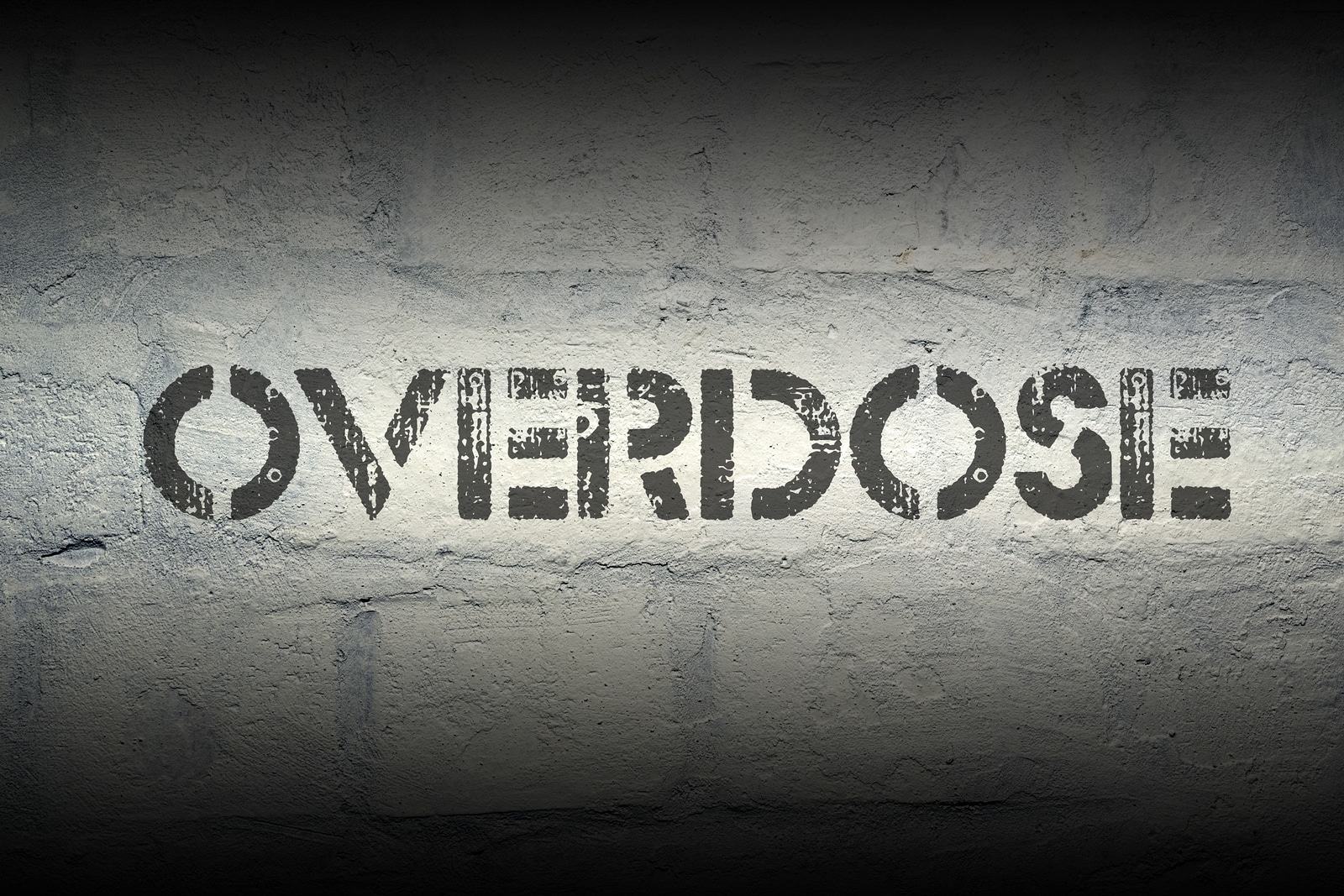 overdose stencil print on the grunge white brick wall | Drug overdose