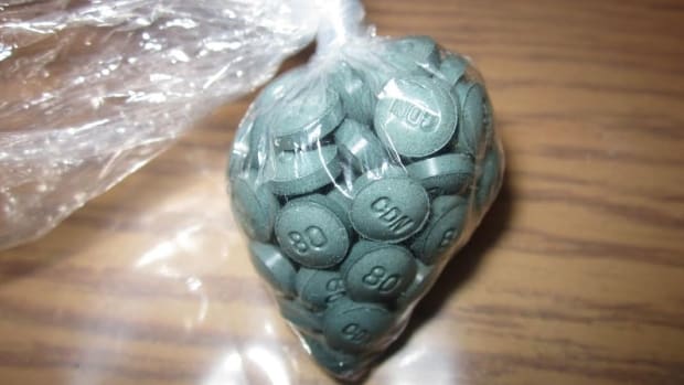 Plastic bag filled with w-18 opioid pills on a table