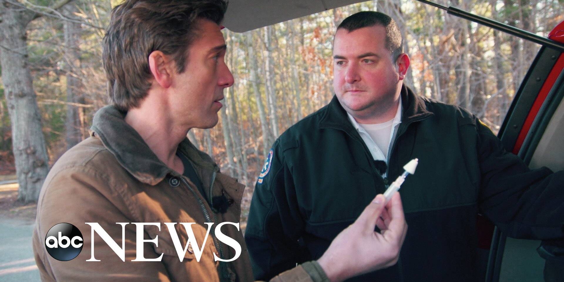 abc News logo on image of man holding syringe next to another man at the back of a vehicle.