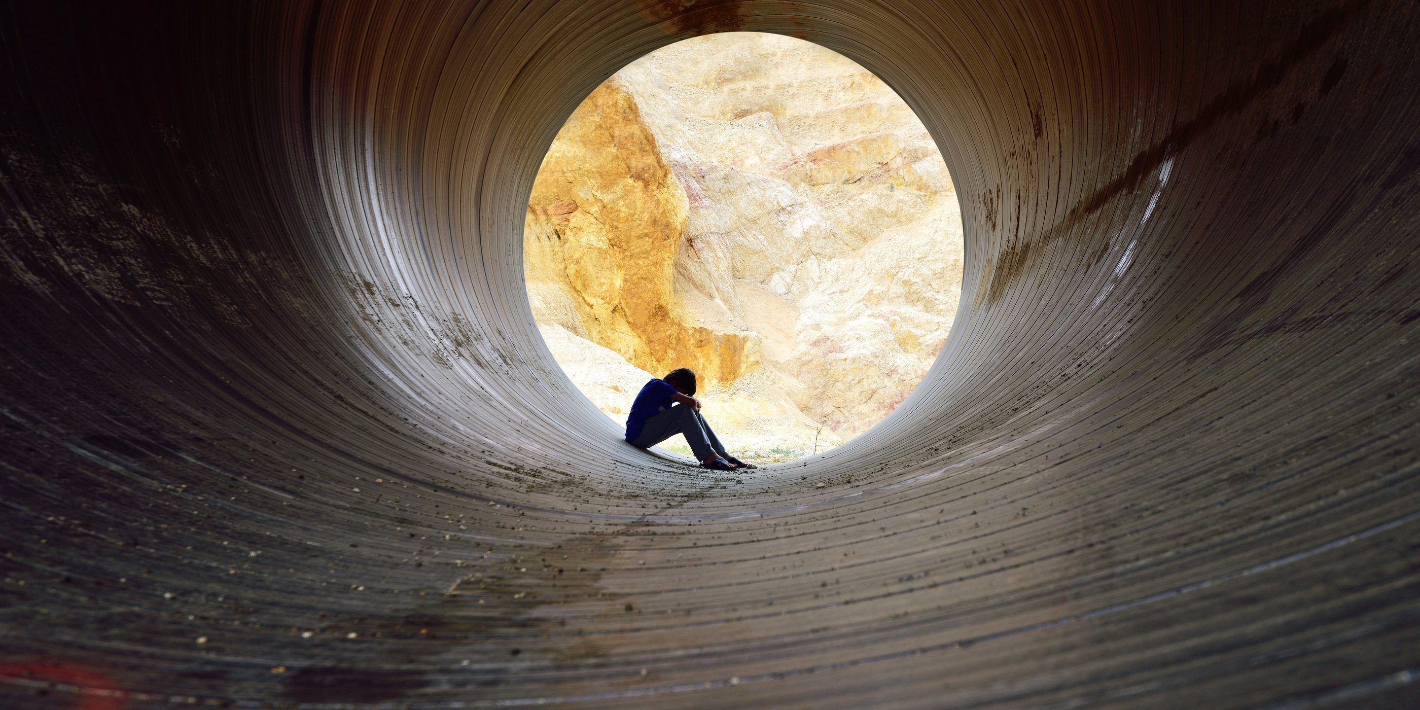 Depressed Young Man Sitting In The Drain tunnel.