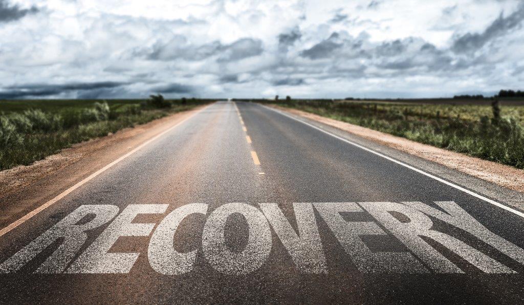 Recovery written on road. Freedom from opioids with inpatient detox treatment