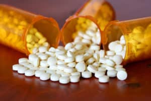 Percocet spilling out of bottles laying down