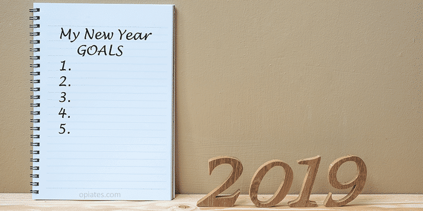 Notepad with New Year GOALS written on notepad; illustrates new years resolutions tips to prevent addiction issues