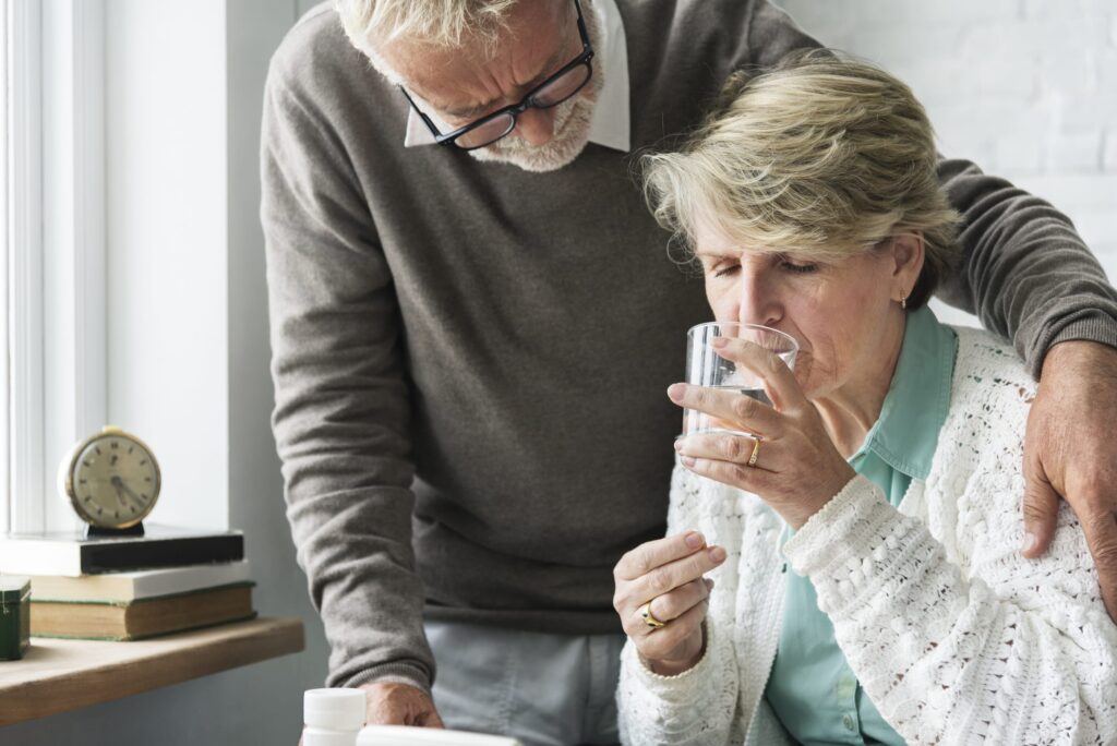 senior male comforts senior female pain patient taking prescription opioids with new FDA guidelines for discontinuation