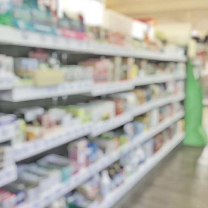 Over the Counter OTC Drugs - Pharmacy store or drugstore blur background with drug shelf and blurry pharmaceutical products, cosmetic and medication supplies on shelves inside retail shop interior