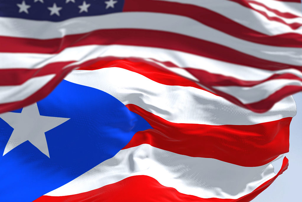 Photo of Flag of Puerto Rico waving with the United States flag on a clear day. Concept of Rapid Detox in Puerto Rico