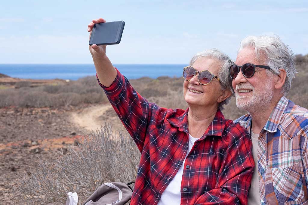 A happy elderly couple on a hike. A concept of addiction recovery after medical detox