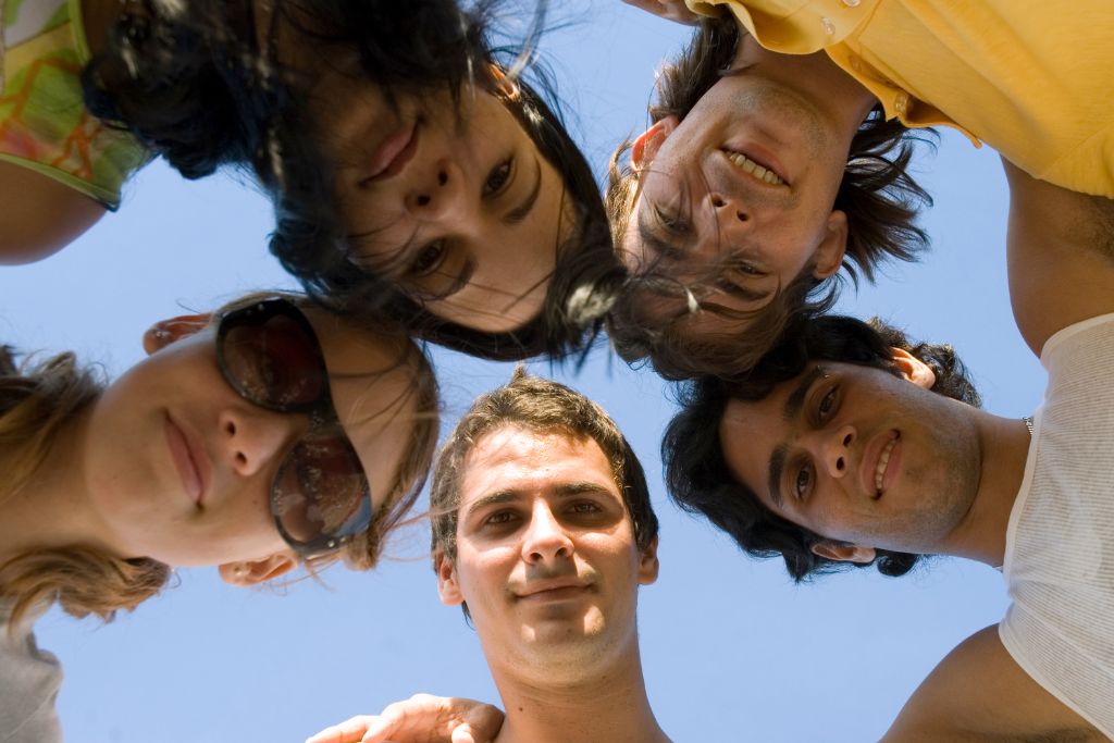 Community Support for Substance Prevention in Young People Concept - photo of five young diverse individuals in a circle looking down at the camera lens