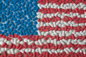 American flag depicting in red white and blue pills. Concept of history of opioids in america