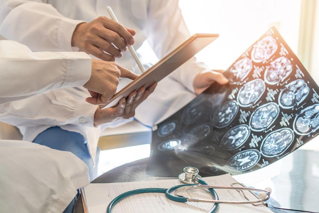 Photo closeup of medical team, surgical doctor teamwork, professional brain and neurological surgeon with digital tablet working in hospital clinic discussion, diagnosing on patient care. Concept of brain injury after overdose.