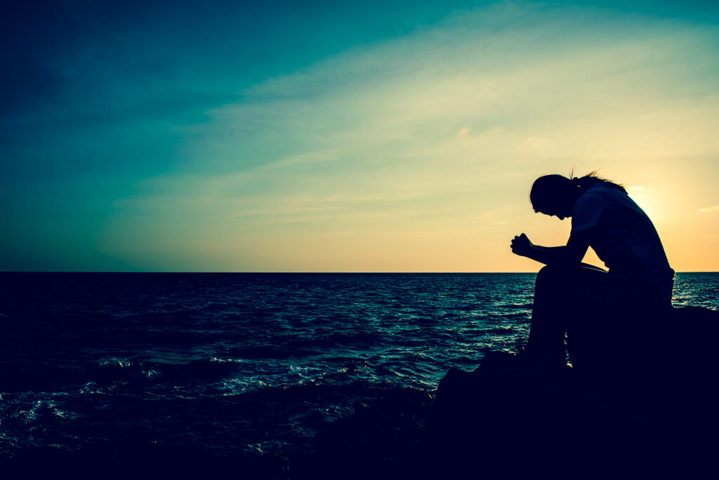 A Save Download Preview Silhouette women sitting alone on the rock representing the use of drugs and suicide.
