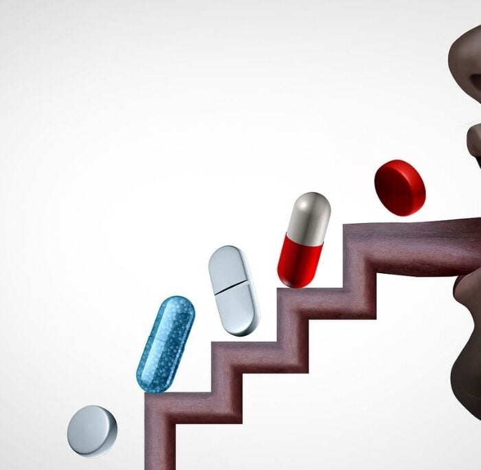 pills going up a tongue shaped as stairs to describe substance abuse concept as over-prescribed medication